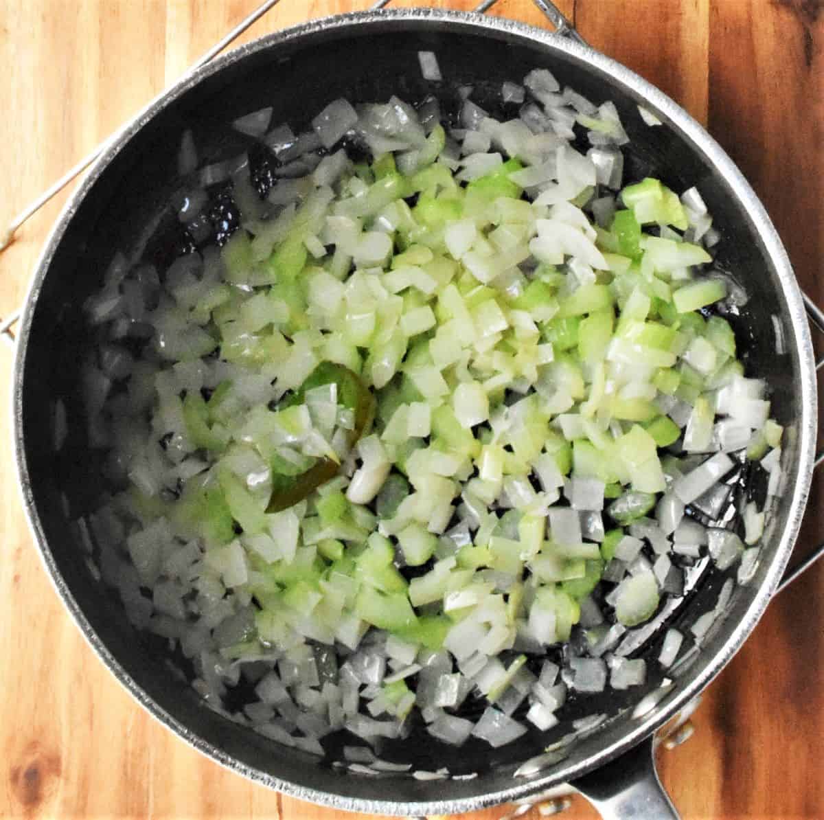 Cooking onion and celery in soup pot.