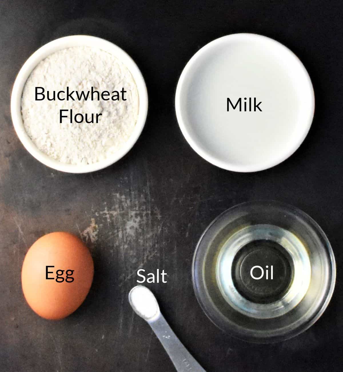 Ingredients for making buckwheat crepes in individual dishes.