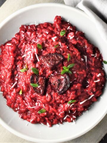 Top down view of beet risotto in grey bowl.