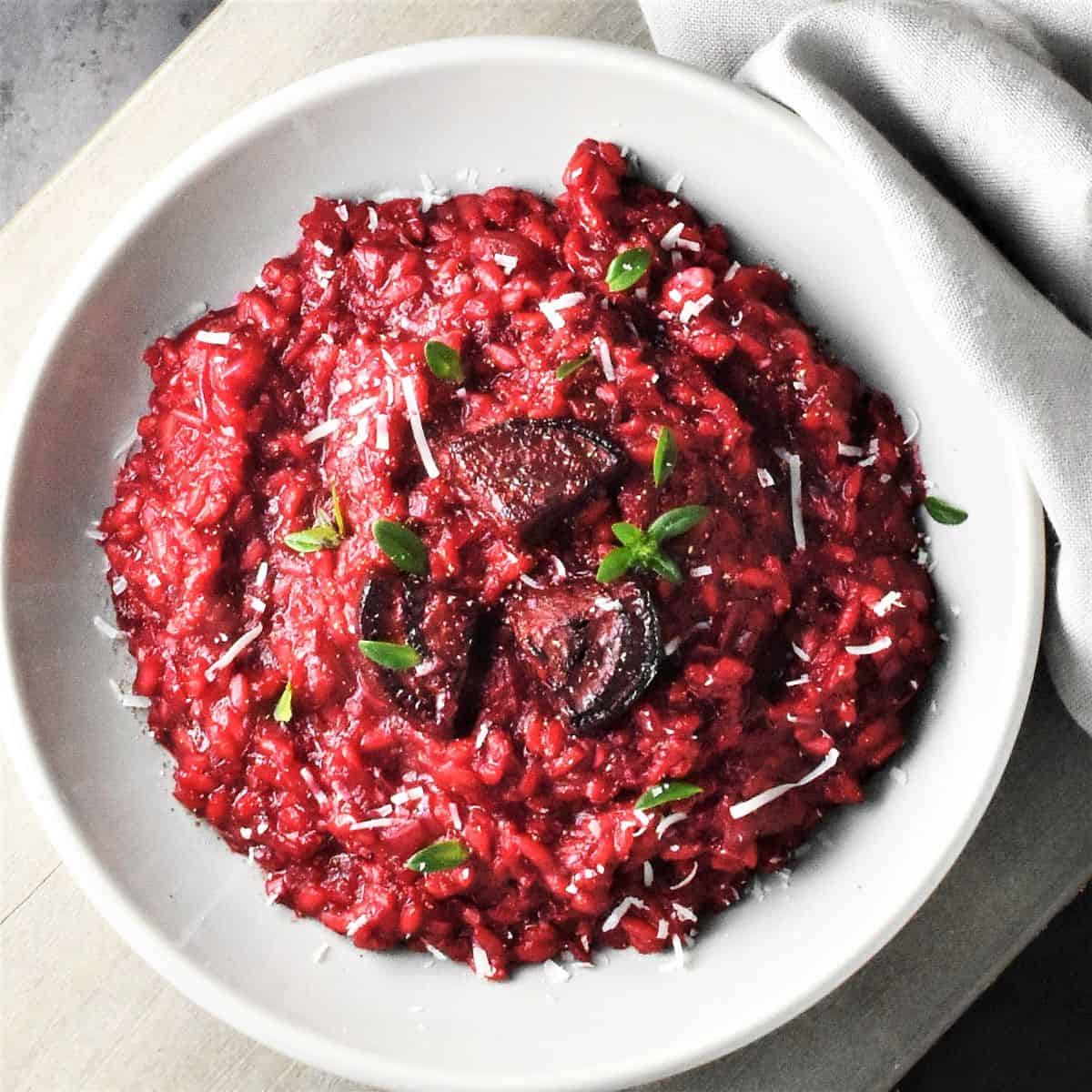 Top down view of beet risotto in grey bowl.
