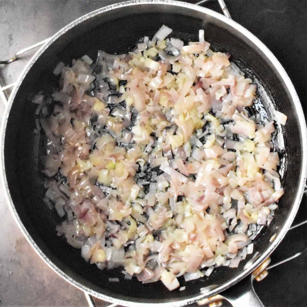 Chopped shallots in large pot.