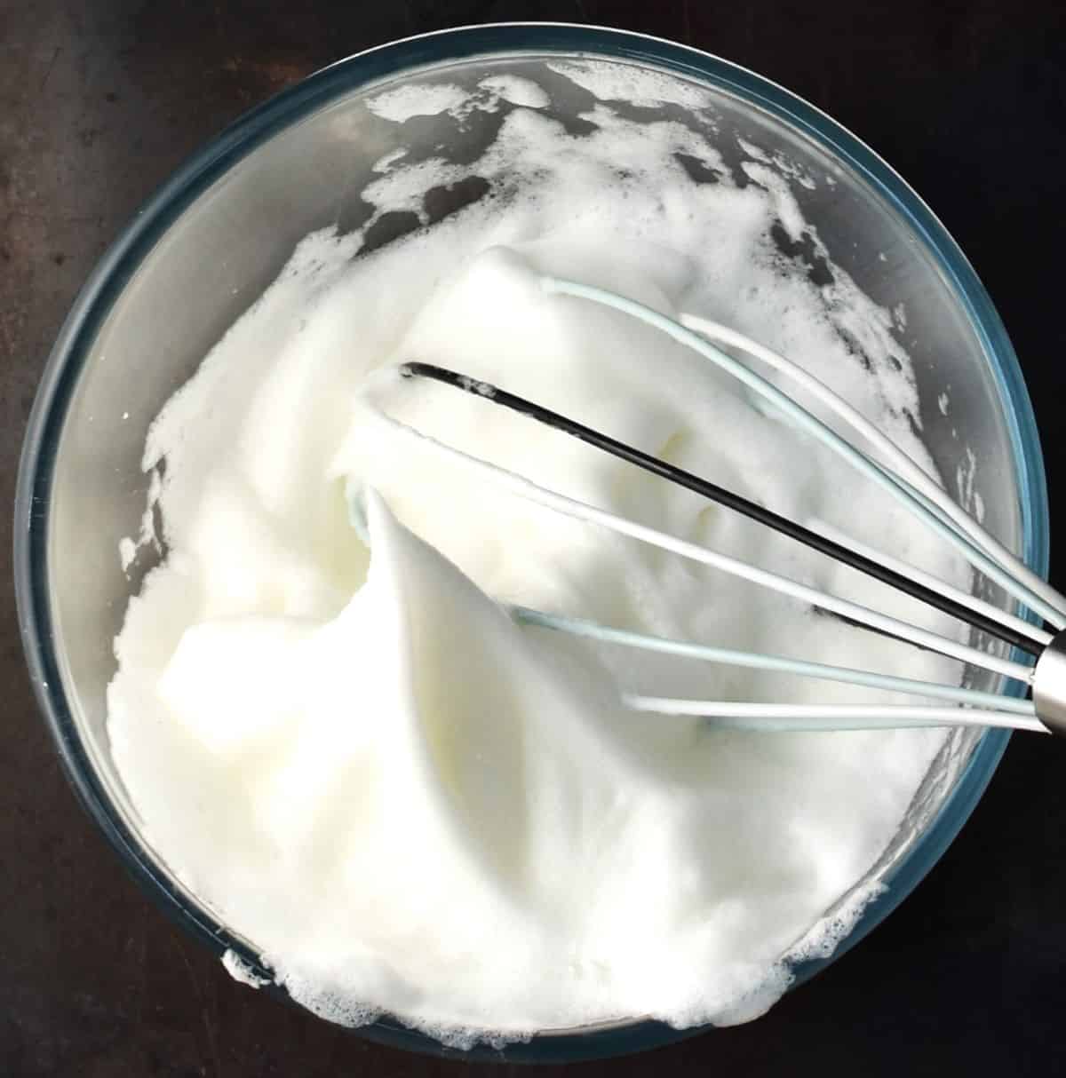 Beaten egg whites in mixing bowl with whisk.