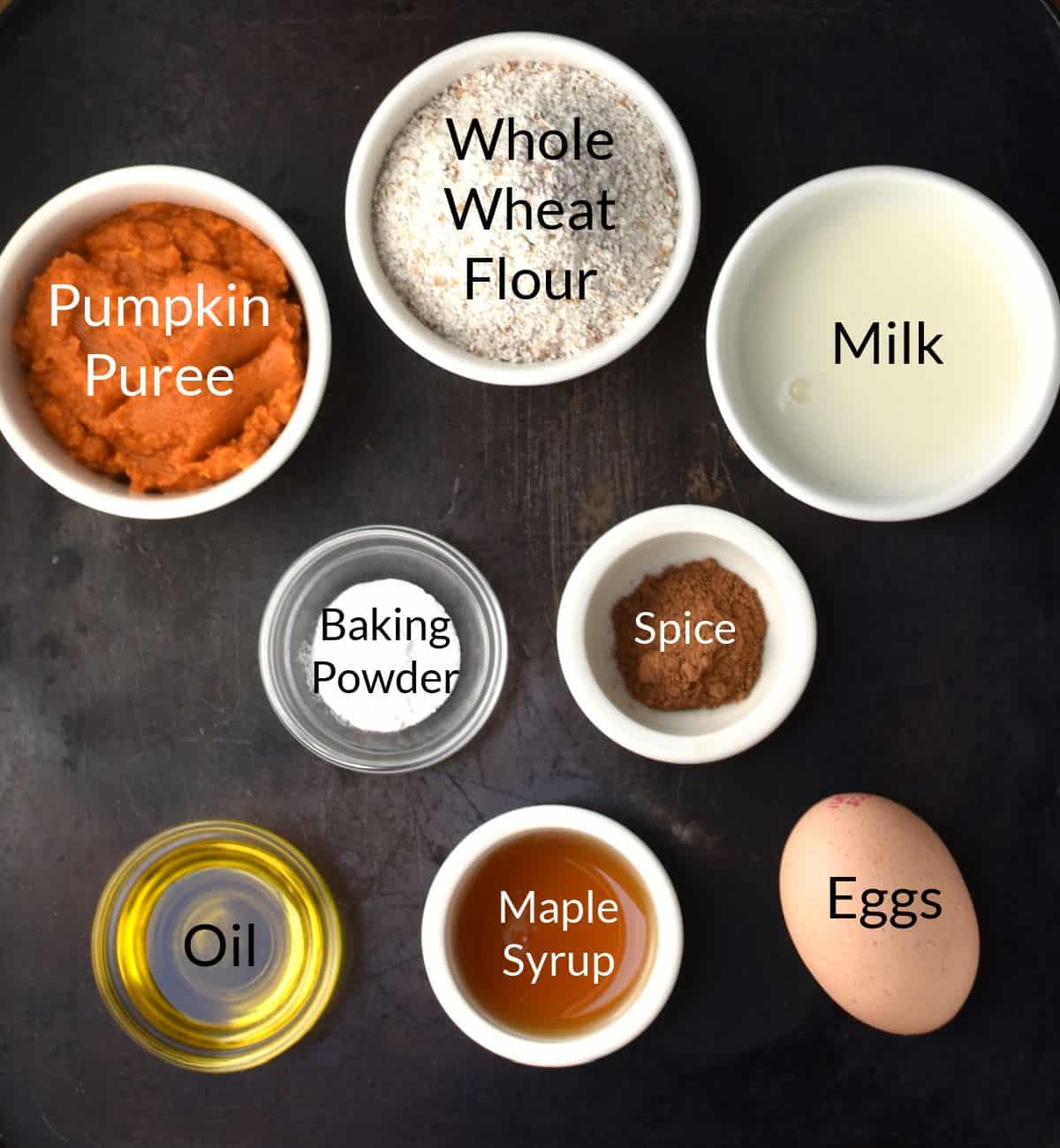 Ingredients for making healthy pumpkin pancakes in individual dishes.