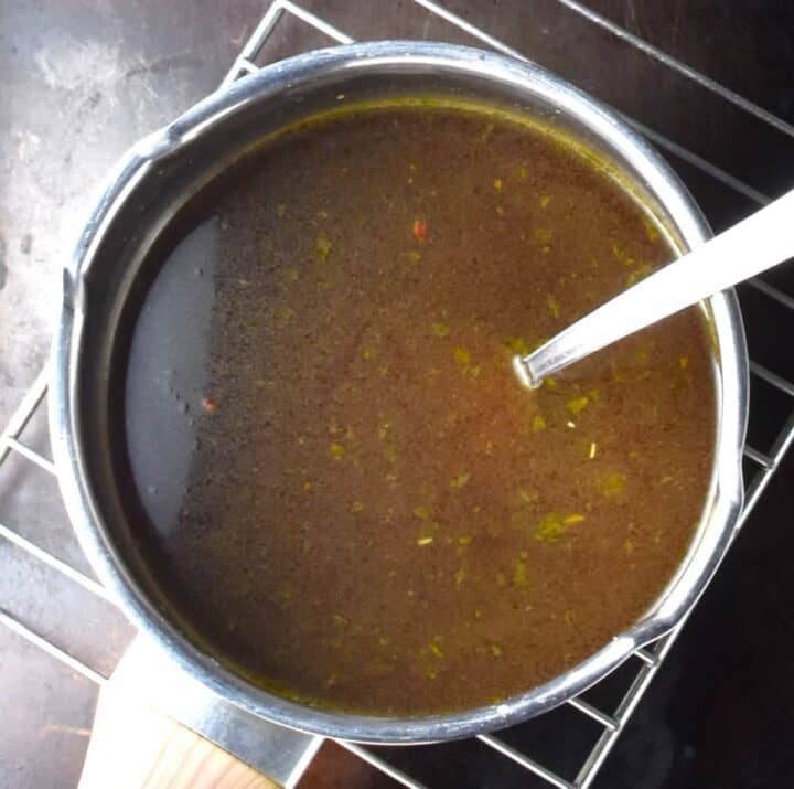 Stock in pot with spoon.