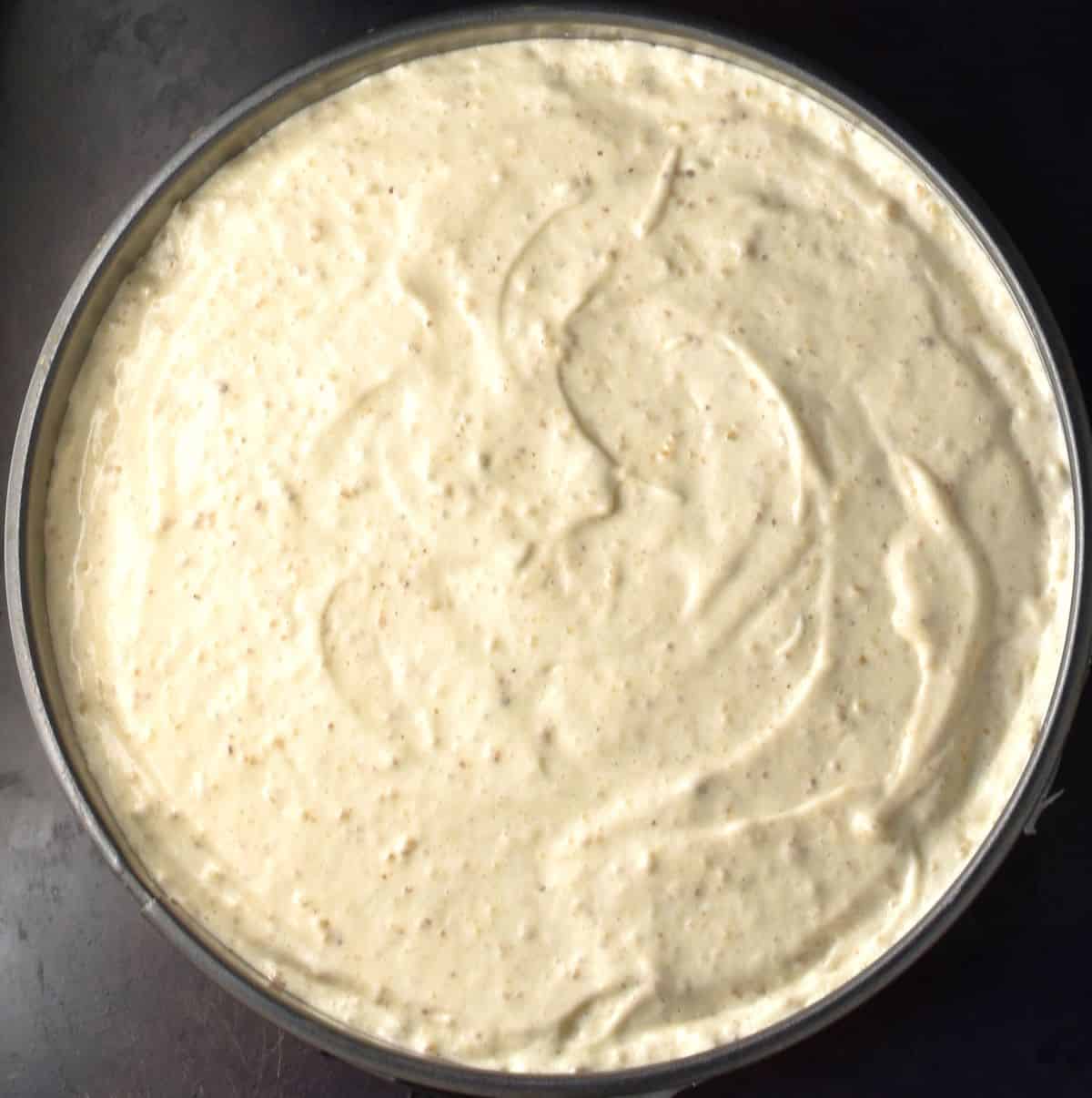 Top down view of cake batter in round pan.