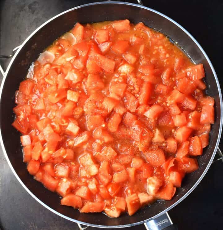 Finely chopped tomatoes in pan.