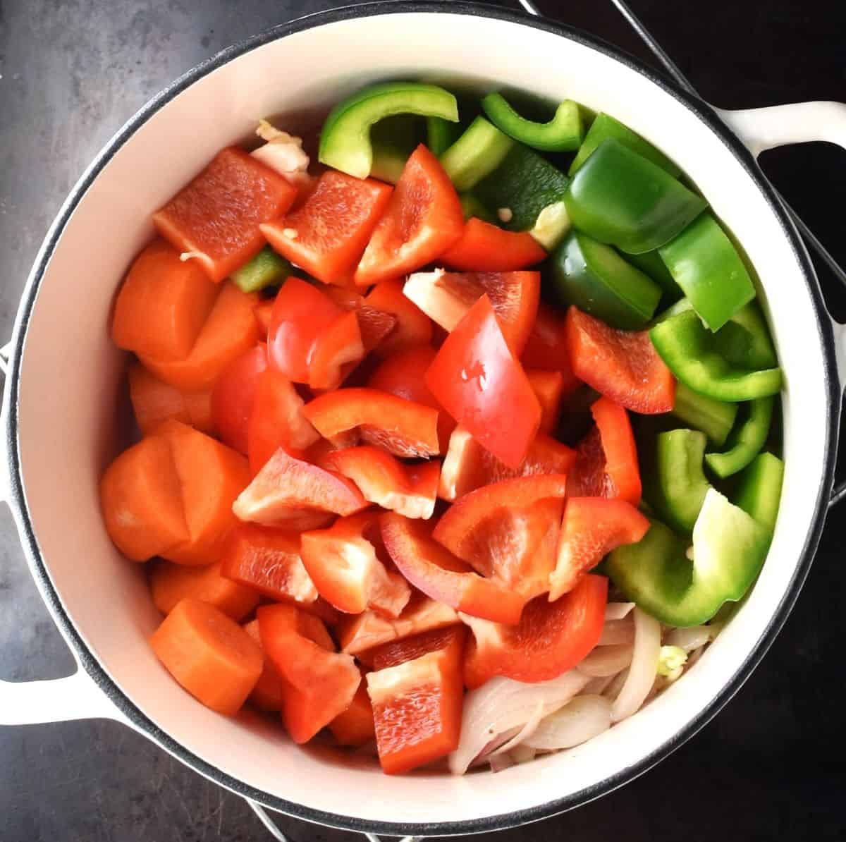 Chopped peppers for vegetable goulash in pot.