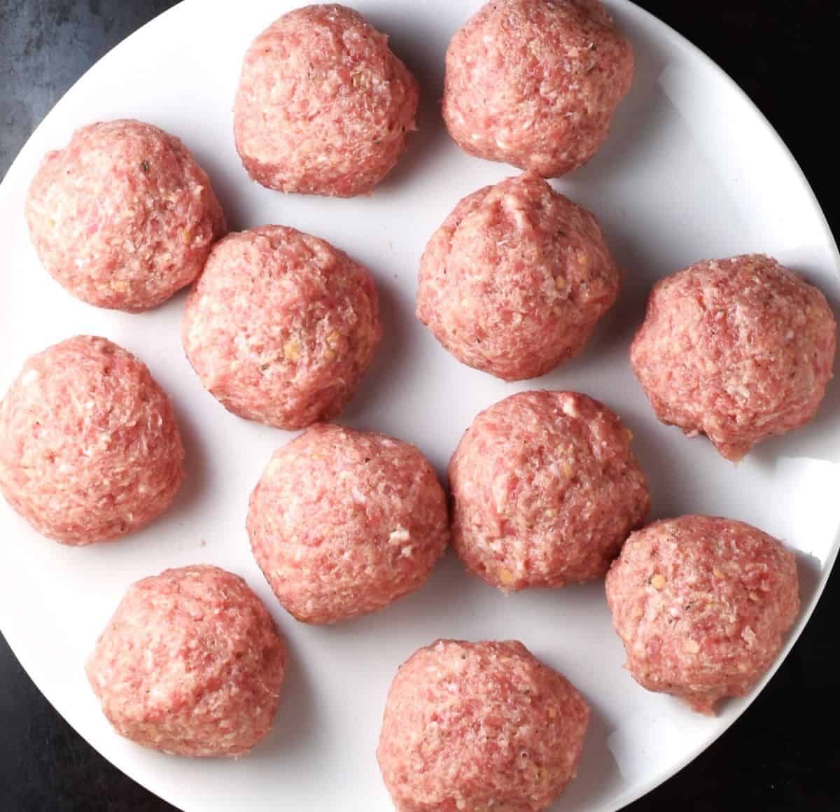 1 large pulpety meatballs on white plate.