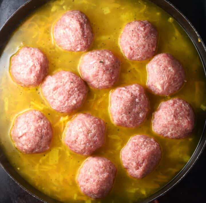 12 Polish meatballs in broth in large pan.