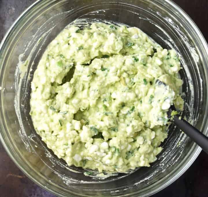 Cottage cheese avocado mixture in glass bowl.