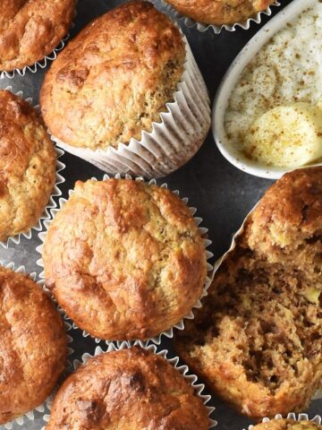 Top down view of cottage cheese banana muffins in paper cases close together.