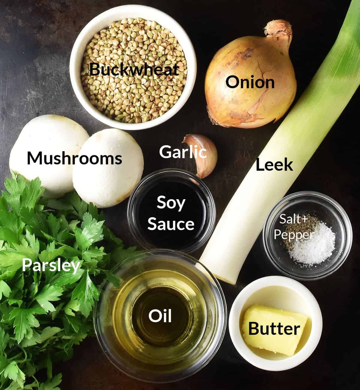 Top down view of ingredients for buckwheat with mushrooms in individual dishes.