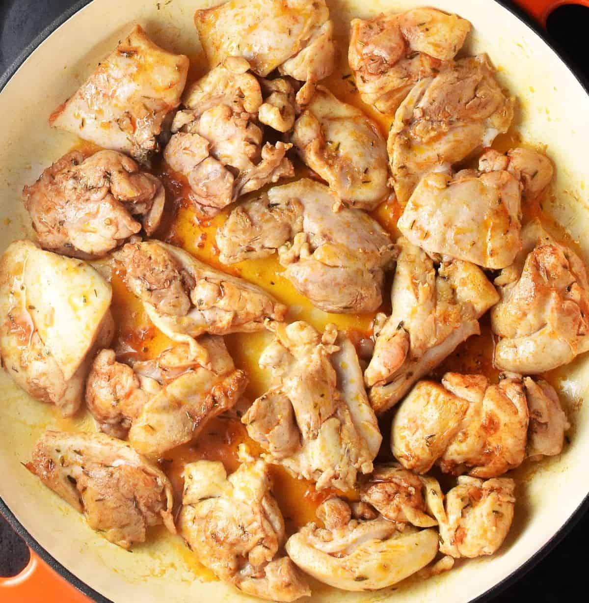 Seared pieces of chicken in large, white dish.