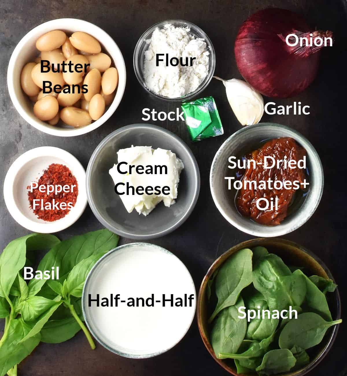 Top down view of marry me butter beans ingredients in small dishes with labels.